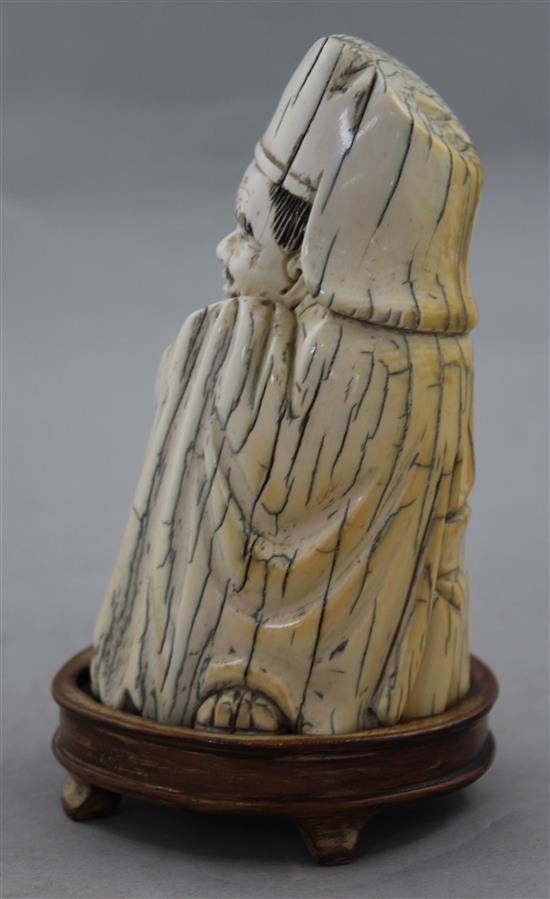 A Chinese mammoth ivory tusk carving of a seated figure of Li Bai, 20th century, 14cm, wood stand